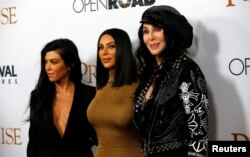 Singer Cher (R) poses with television personalities Kim Kardashian (C) and Kourtney Kardashian at the premiere of "The Promise" in Los Angeles, California, April 12, 2017.