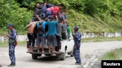 FILE - Ethnic Rakhine people who fled from Maungdaw after Arakan Rohingya Salvation Army (ARSA) had attacked, arrive in Buthidaung, Myanmar, Aug. 28, 2017.