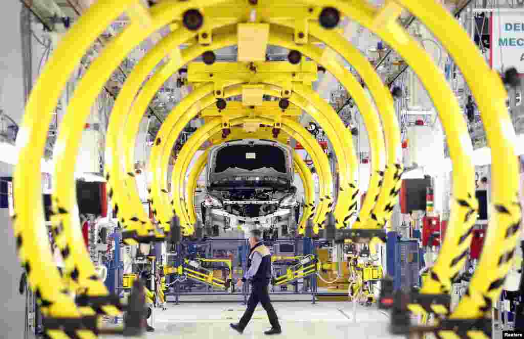 An employee walks through the Maserati&#39;s new manufacturing factory in Turin, Italy.