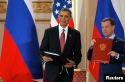 FILE - U.S. President Barack Obama and Russian President Dmitry Medvedev show signed copies of the new Strategic Arms Reduction Treaty (START II) at Prague Castle in Prague, April 8, 2010.