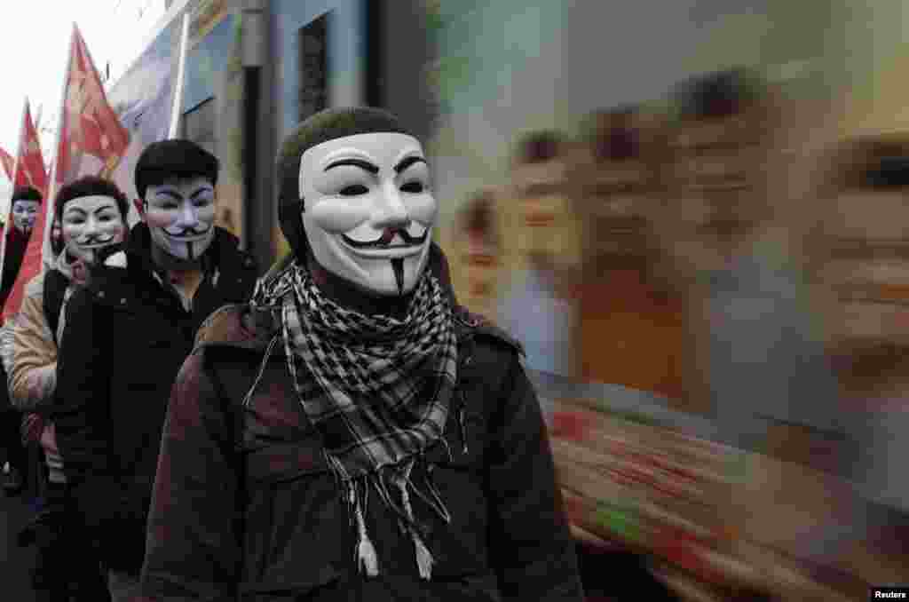 High school students wearing Guy Fawkes masks take part in a protest against the education policies of the ruling AK Party as a tram drives by in Istanbul, Turkey. Education is the latest flashpoint between the administration of President Tayyip Erdogan, and secularist Turks who accuse him of overseeing creeping &#39;Islamization&#39; in the NATO member state.