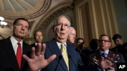 FILE - Senate Majority Leader Mitch McConnell, R-Ky., joined by, from left, Sen. John Barrasso, R-Wyo., Sen. John Thune, R-S.D., and Majority Whip John Cornyn, R-Texas, speaks following a closed-door strategy session, at the Capitol in Washington, June 20, 2017.