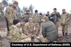 FILE - Ukrainian soldiers learn battle skills such as first aid from U.S. Army troops at the International Peacekeeping and Security Center in western Ukraine.