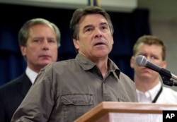 Gov. Rick Perry (C) speaks during a news conference updating information about the state's emergency response to the explosion and fires in West, Texas, April 18, 2013, in Austin, Texas.