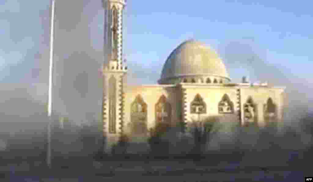 This image from an amateur video purports to show smoke near a mosque in Homs. (AP, via APTN)