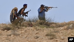Libyan revolutionary fighters look for a target outside Sirte, Libya, Thursday, Sept. 29, 2011.