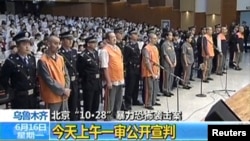 FILE - The trial of three people sentenced to death for their roles in an October attack on the edge of Beijing's Tiananmen Square is seen in this still image taken from video in Urumqi city, June 16, 2014. 