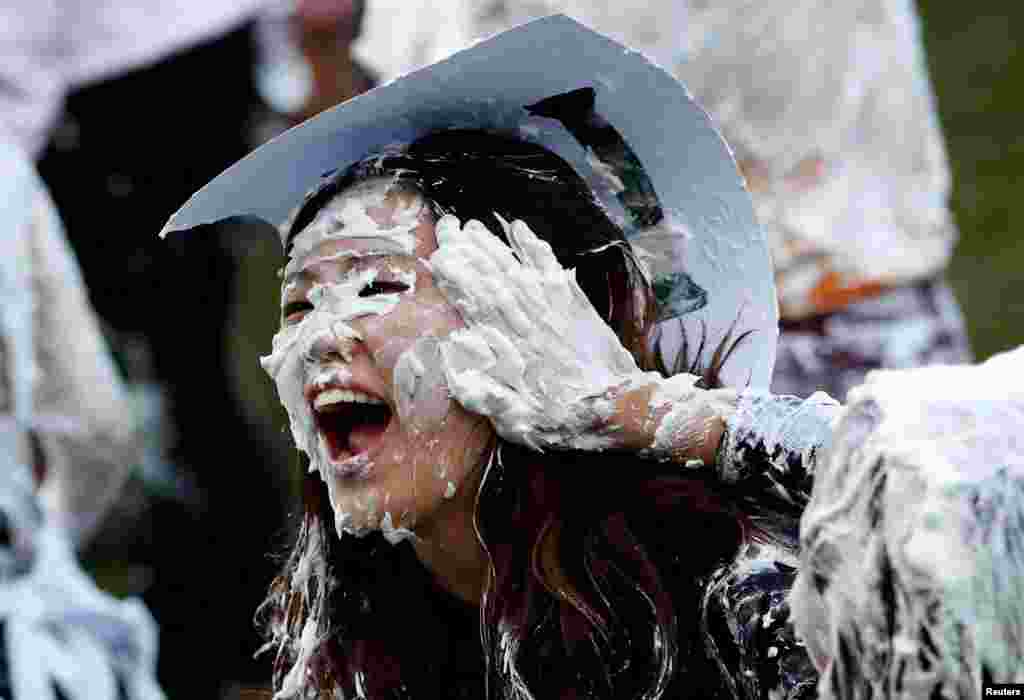 Students from St. Andrews University are covered in foam as they take part in the traditional &#39;Raisin Weekend&#39; in the Lower College Lawn, at St Andrews in Scotland, Britain.