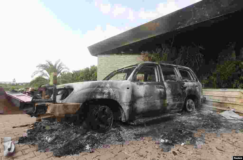 A burnt car is parked at the U.S. consulate, which was attacked and set on fire by gunmen, in Benghazi, Libya, September 12, 2012. 