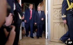FILE - U.S. President Donald Trump, left, and Russian President Vladimir Putin arrive for a one-on-one-meeting at the Presidential Palace in Helsinki, Finland, July 16, 2018.