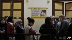 Egyptian women queue to vote in a polling station in Cairo, Egypt, Monday, Nov. 28, 2011