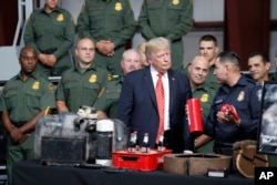 President Donald Trump is shown methods of narcotics smuggling during a tour of U.S. Customs and Border Protection Border equipment at their airport hanger at Marine Corps Air Station Yuma, Aug. 22, 2017, in Yuma, Arizona.
