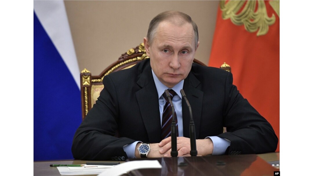 FILE - Russian President Vladimir Putin heads a Cabinet meeting in Moscow, April 12, 2017.