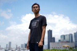 Documentary filmmaker Kiwi Chow, 42, poses for a photograph at Kwun Tong Ferry Pier near his studio in Hong Kong, China, June 18, 2021.