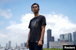 Documentary filmmaker Kiwi Chow, 42, poses for a photograph at Kwun Tong Ferry Pier near his studio in Hong Kong, China, June 18, 2021.