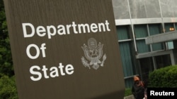 A woman leaves the U.S. State Department building in Washington June 5, 2009