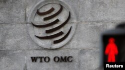 FILE - A logo is pictured outside the World Trade Organization (WTO) headquarters next to a red pedestrian traffic light, in Geneva, Switzerland, Oct. 2, 2018.