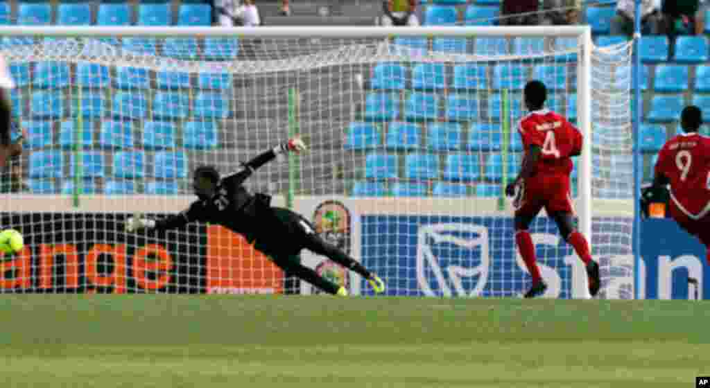 Sudan's Saif Eldin and Nagm Eldin look on as Angola's Manucho scores during their African Nations Cup soccer match in Malabo