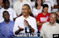 FILE - Florida Democratic gubernatorial nominee Andrew Gillum, left, and Senator Bill Nelson (D-FL), right, listen to former President Barack Obama as he addresses the media and supporters as they stump for votes at a rally in Miami, Florida, Nov. 2, 2018.