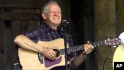 Master flatpicker Doc Watson performs at the annual Merlefest at Wilkes Comunity College in Wilkesboro, N.C. (2001 file photo)