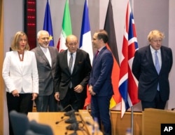 (L-R) European Union foreign policy chief Federica Mogherini, Iranian Foreign Minister Javad Zarif, French Foreign Minister Jean-Yves Le Drian, German Foreign Minister Heiko Maas and British Foreign Secretary Boris Johnson pose for a photo during a meeting of the foreign ministers from Britain, France and Germany with the Iran Foreign Minister and EU foreign policy chief Federica Mogherini, at the Europa building in Brussels, May 15, 2018.
