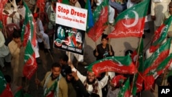 A supporter of Pakistan's Tehreek-e-Insaf party, headed by cricketer-turned politician Imran Khan, holds up a poster and shouts slogans during a protest against U.S. drone strikes in Pakistan, in Peshawar, Pakistan, Nov. 23, 2013.