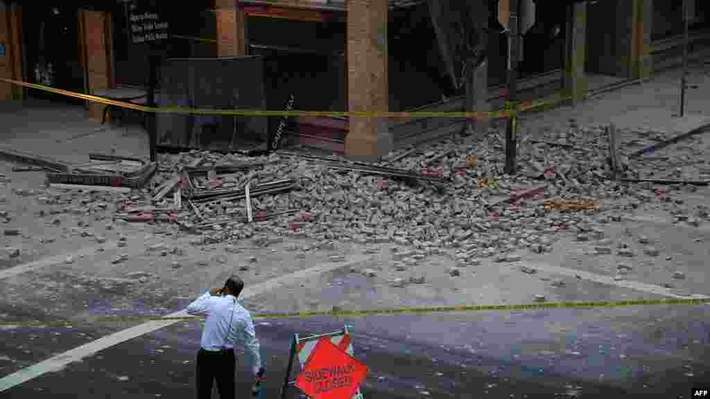 A reporter surveys the scene of a building collapse following a reported 6.1 earthquake in Napa, California, Aug. 24, 2014.