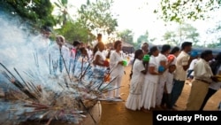 People in Columbo, Sri Lanka, shown here making offerings to the Buddha, are part of the Indo-European language group which also includes English and Germanic languages. (Creative Commons Original Nomad)