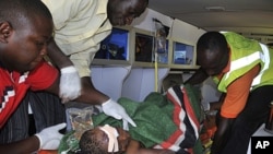 A victim is tended to by medics in an ambulance following a blast at a Catholic church near Nigeria's capital Abuja, December 25, 2011.