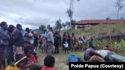 Sejumlah masyarakat di Kampung Mamba Distrik Sugapa, Kabupaten Intan Jaya, Papua, mengerumuni jenazah seorang warga sipil yang tewas ditembak kelompok bersenjata. Sabtu 30 Mei 2020. (Foto: Polda Papua)