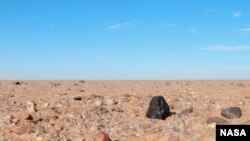 A Small asteroid 2008 TC3 fell to Earth at dawn on October 7, 2008, tracking through the skies over the Nubian Desert in northern Sudan. A search for surviving fragments led on Dec. 6, 2008 to the discovery of the first meteorite, out of a total of 280 small meteorites that were collected, now called Almahata Sitta. (Peter Jenniskens (SETI Institute/NASA Ames)