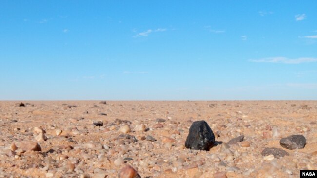 FILE - A small asteroid, 2008 TC3, fell to Earth at dawn on Oct. 7, 2008, tracking through the skies over the Nubian Desert in northern Sudan.