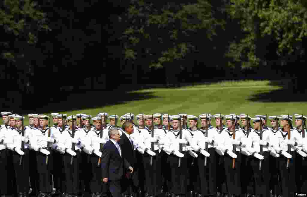 U.S. President Barack Obama reviews an honor guard with German President Joachim Gauck at Schloss Bellevue in Berlin, Germany.