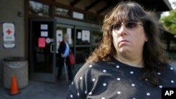 Jessica Tunis stands outside a Red Cross evacuation center, Oct. 11, 2017, in Santa Rosa, California. Tunis is searching for her missing mother, Linda Tunis, who was living at a mobile home park when wildfires struck.