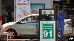 A worker refuels a car at a gas station in Jiddah, Saudi Arabia, Monday, Sept. 16, 2019.