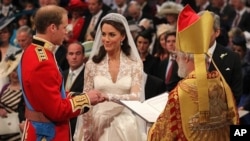 Britain's Prince William and Kate Middleton exchange rings in front of the Archbishop of Canterbury at Westminster Abbey, London, Friday April 29, 2011.