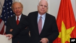 US Senator John McCain (R) speaks next to US Senator Joseph Lieberman (on left) at a press conference in Hanoi on January 19, 2012.