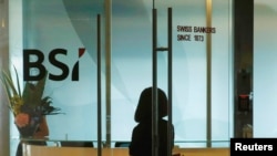 An employee enters the reception area of Swiss bank BSI's office in Singapore, May 24, 2016.