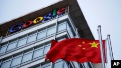 FILE - The Chinese flag is seen near the Google sign at the Google china headquarters in Beijing, China.