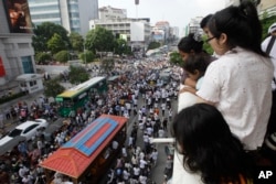 FILE - People watch the funeral procession of Cambodian leading government critic Kem Ley in Phnom Penh, Cambodia, July 24, 2016.