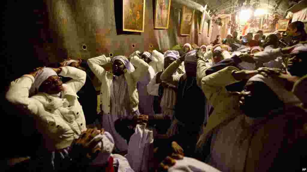 Des pèlerins chrétiens du Nigeria prient l&#39;intérieur de la grotte de l&#39;église de la Nativité, traditionnellement considérée par les chrétiens comme le lieu de naissance de Jésus-Christ, dans la ville de Bethléem en Cisjordanie, la veille de Noël, mercredi 24 décembre 2014.