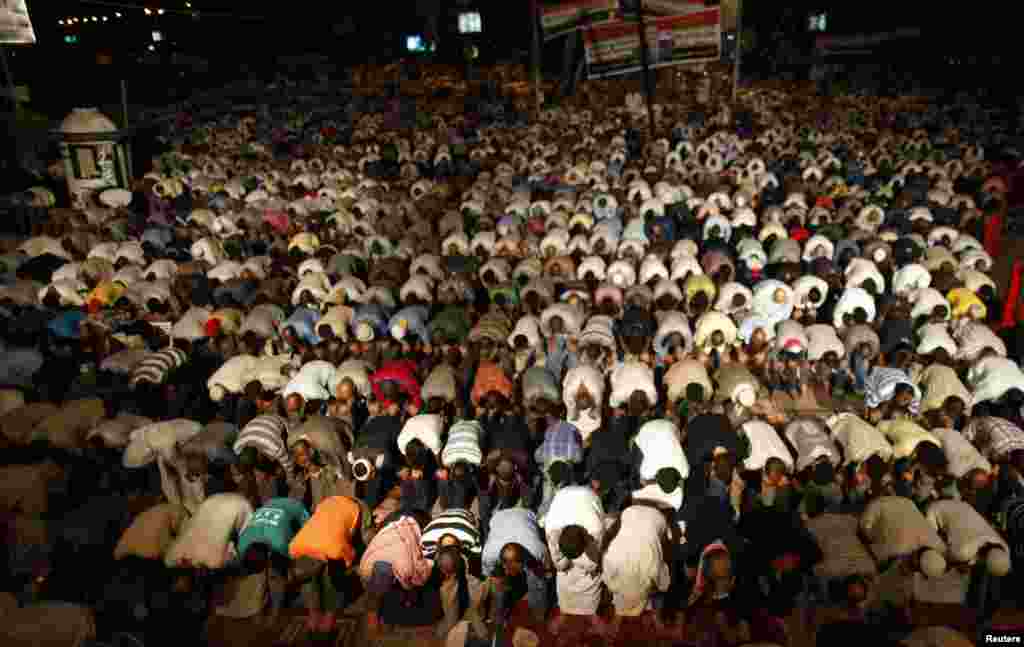 Supporters of deposed Egyptian President Mohamed Morsi perform dawn prayers at the Rabaa Adawiya square, Cairo, where they are camping, July 9, 2013.