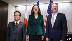 From left, Japanese Minister of Economy, Trade and Industry, Hiroshige Seko, European Commissioner for Trade, Cecilia Malmstrom, and U.S. Trade Representative Robert Lighthizer, pose for media before meeting in Washington, Jan. 9, 2019. 