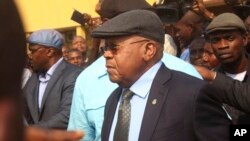 FILE - Etienne Tshisekedi, center, is greeted by supporters at the airport in Kinshasa, Congo, July 27, 2016 file photo. He died in February 2017 of a pulmonary embolism while in Belgium.