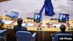 FILE - Shaharzad Akbar (on screens) of the Afghanistan Independent Human Rights Commission addresses a Security Council meeting, Aug. 6, 2021. She again spoke at the U.N. on Sept. 24, 2021, urging global leaders to pressure the Taliban to let girls go to school.