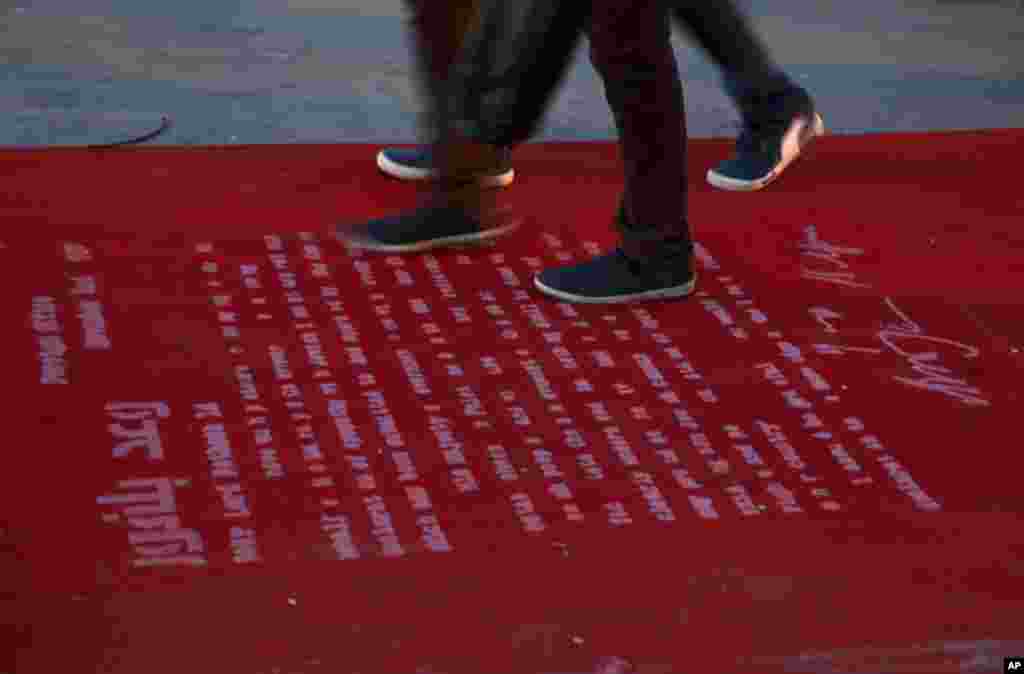 Youths step on text of the Balfour Declaration, which is printed on a 100-meter red carpet during the opening ceremony of the 3rd Annual Red Carpet Festival for Human Rights Films in Gaza City. The festival coincides with the 100 year-anniversary of the Declaration, which marks the right of return, the release of hunger strikers imprisoned in Israeli jails, the return of national unity and the end of the internal division.