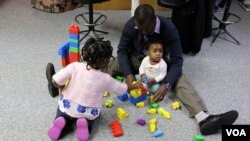 USM graduate student Solomon Nkhalamba at home with his two daughters.