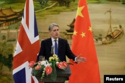 British Foreign Secretary Philip Hammond speaks at a joint news conference with China's Foreign Minister Wang Yi (not seen) after a meeting at the Ministry of Foreign Affairs, in Beijing, China, Jan. 5, 2016.
