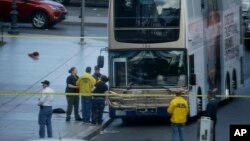 Las Vegas police investigate the scene of a stand-off in a bus along Las Vegas Boulevard in Las Vegas, March 25, 2017.