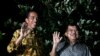 Indonesian president-elect Joko Widodo (l) and his running mate Jusuf Kalla wave to the media at a press briefing in the garden of his home in Jakarta, August 21, 2014.